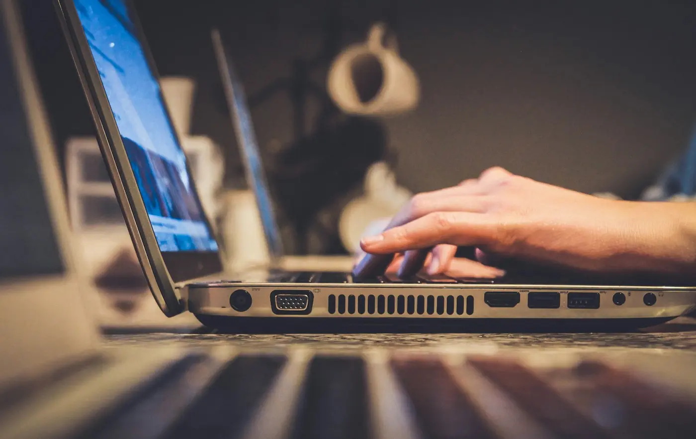 Person using a laptop in a home workspace